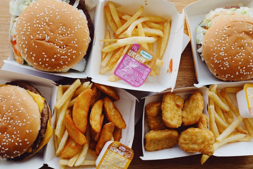 Fast food placed on wooden table