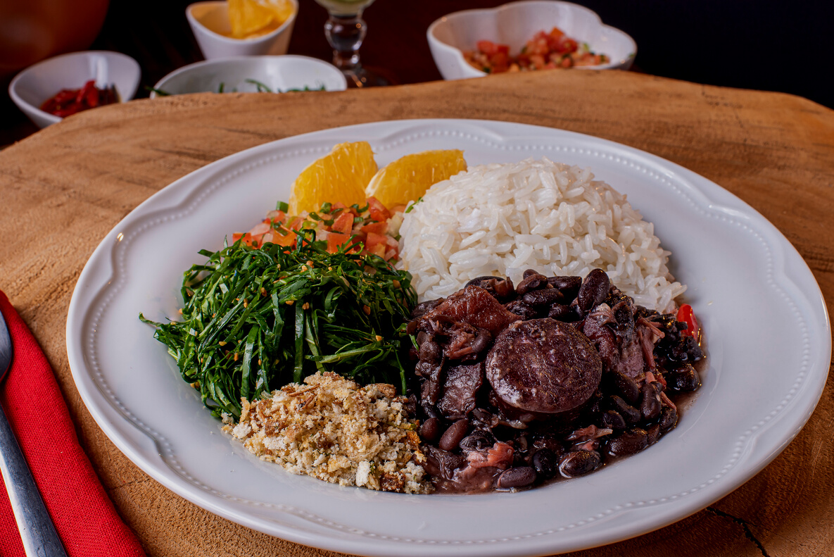 Traditional Brazilian food called Feijoada. Black beans with pork