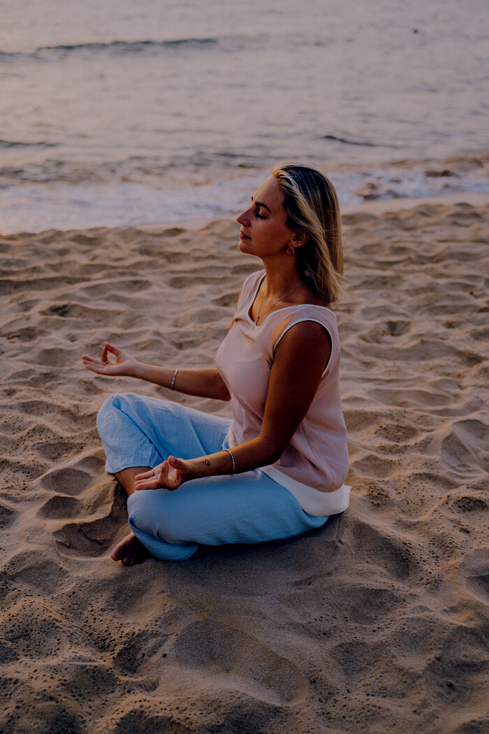 Woman Meditating at the Beach